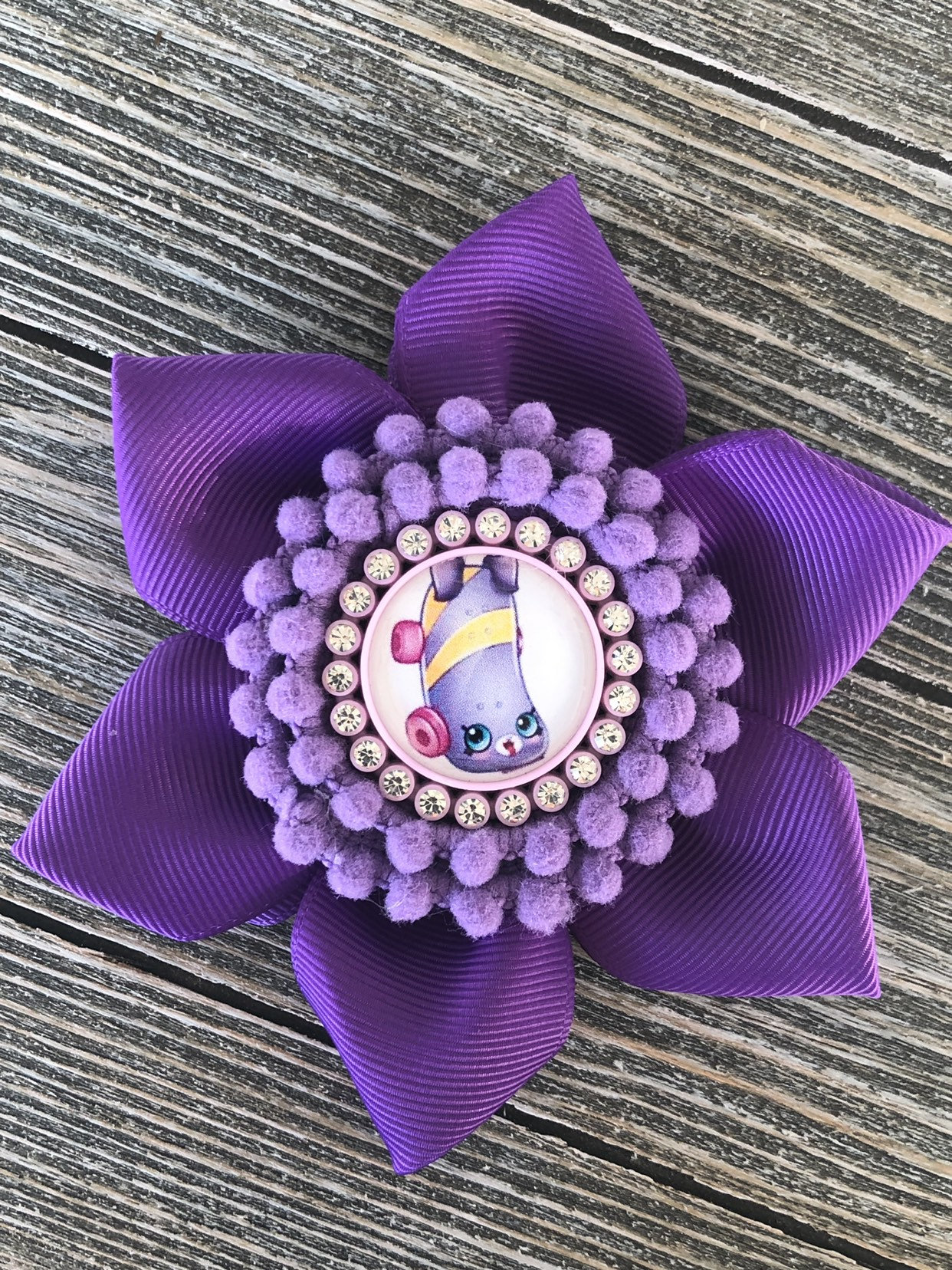 Purple with lavender flower bow with pom poms center